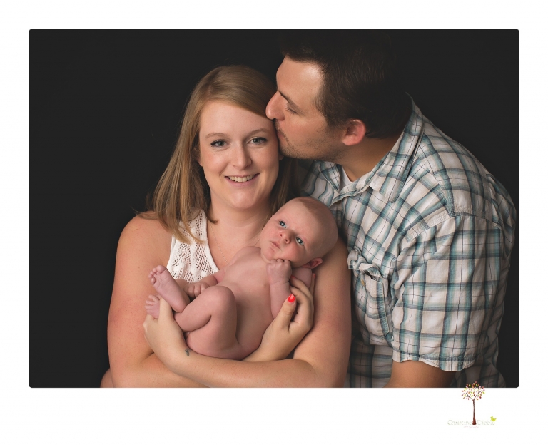 Best Sonora newborn photographer Christine Dibble Photography takes newborn portraits of a baby boy in the studio with his dad's firefighting gear.