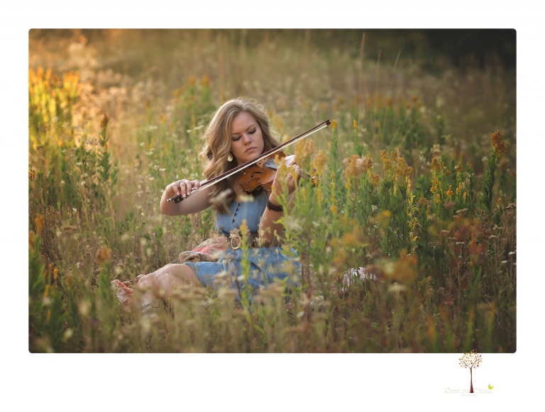 Summerville High senior portrait photographer Christine Dibble Photography of Sonora takes senior portraits of a girl in a field of wildflowers with her violin.