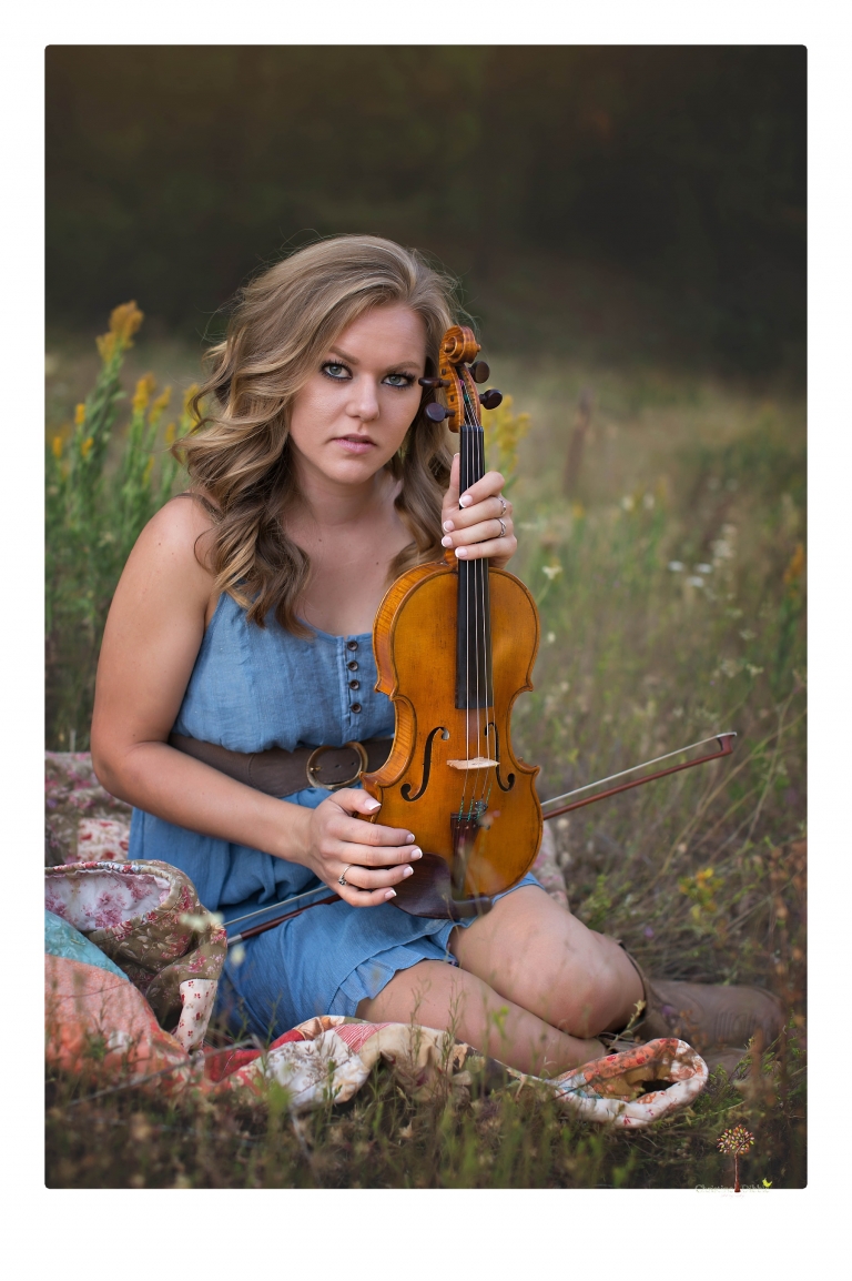 Summerville High senior portrait photographer Christine Dibble Photography of Sonora takes senior portraits of a girl in a field of wildflowers with her violin.