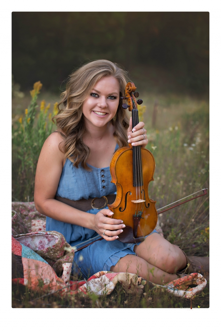 Summerville High senior portrait photographer Christine Dibble Photography of Sonora takes senior portraits of a girl in a field of wildflowers with her violin.