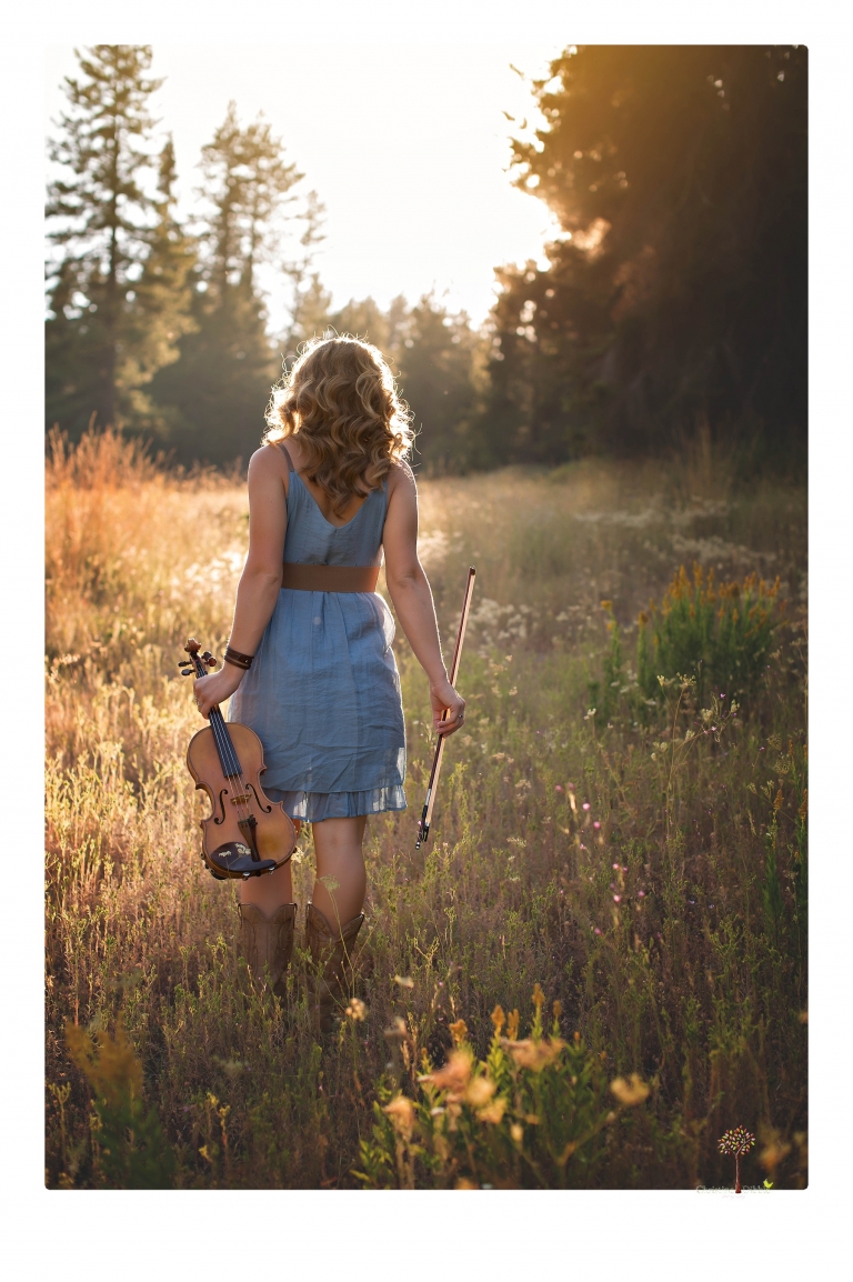 Summerville High senior portrait photographer Christine Dibble Photography of Sonora takes senior portraits of a girl in a field of wildflowers with her violin.