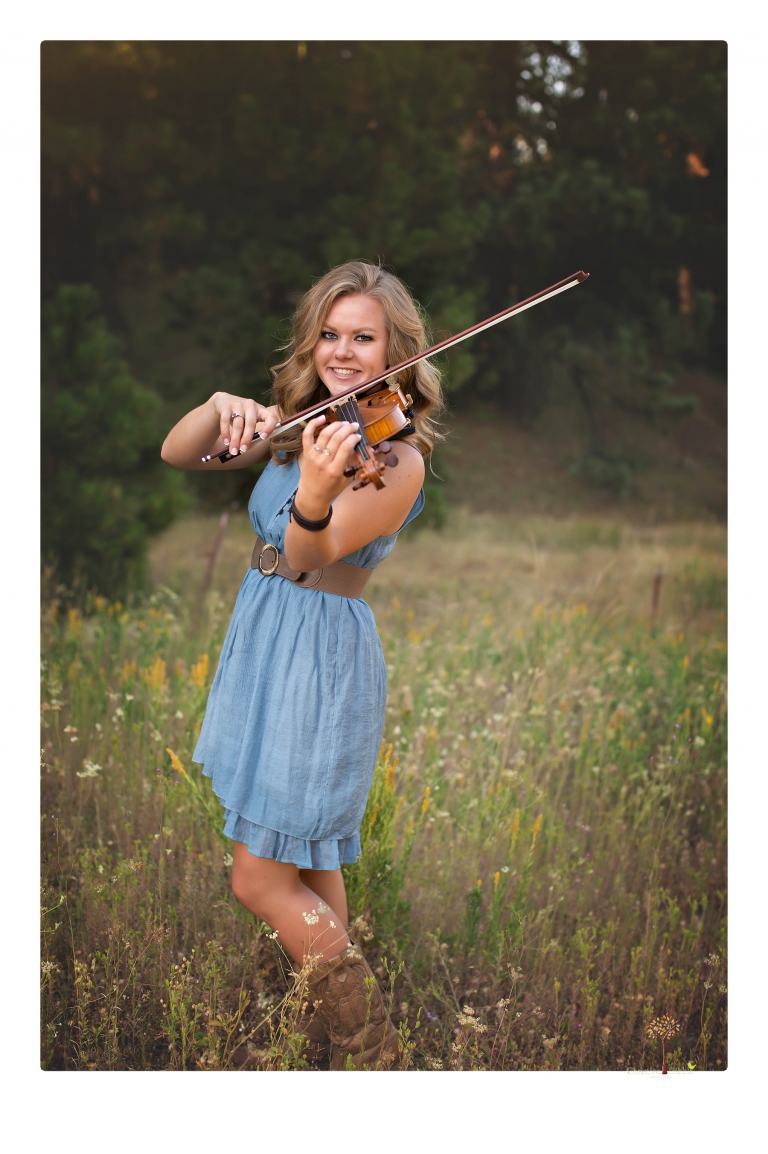 Summerville High senior portrait photographer Christine Dibble Photography of Sonora takes senior portraits of a girl in a field of wildflowers with her violin.