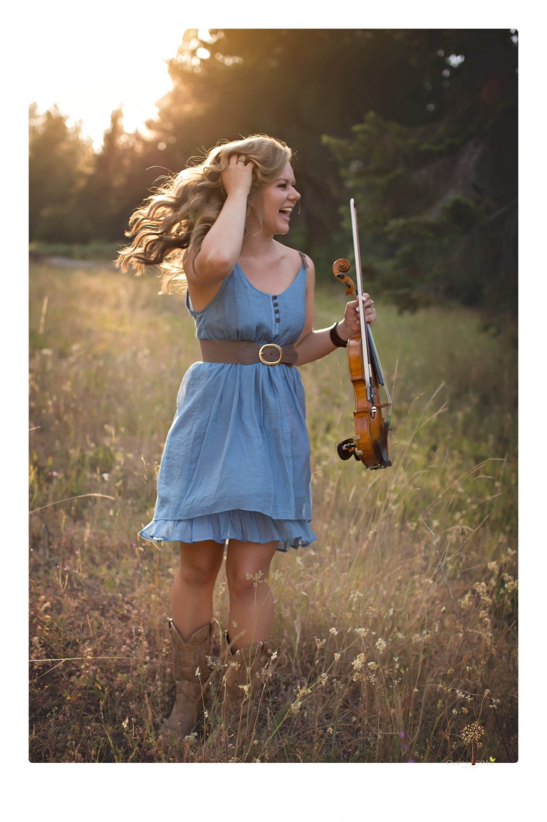 Summerville High senior portrait photographer Christine Dibble Photography of Sonora takes senior portraits of a girl in a field of wildflowers with her violin.