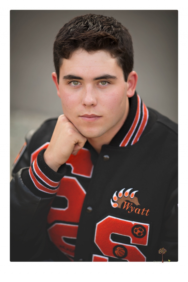 Summerville High senior portrait photographer Christine Dibble of Sonora takes senior portraits of a boy at Twain Harte Tree Farm with his trumpet, letterman jacket, and his dad's classic 1966 Chevelle.
