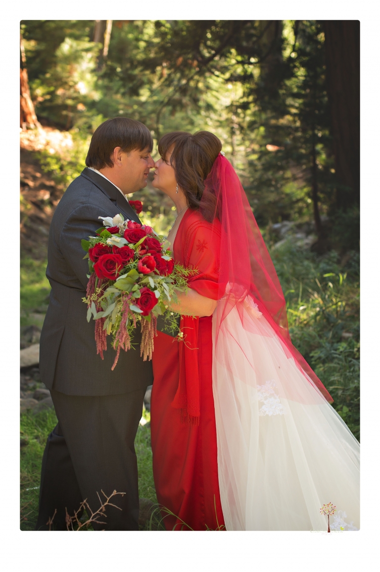 Sonora wedding photographer Christine Dibble Photography takes photos of a weekend wedding at the Pinecrest Chalet where the bride wore a red wedding dress.