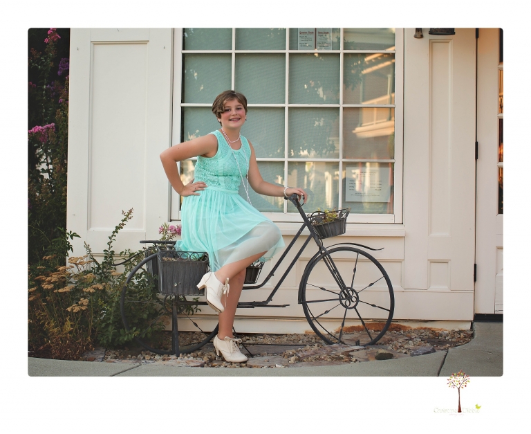 Sonora senior photographer Christine Dibble Photography takes portraits of two cousins dressed as flappers in Copperopolis Town Square before one leaves for college.