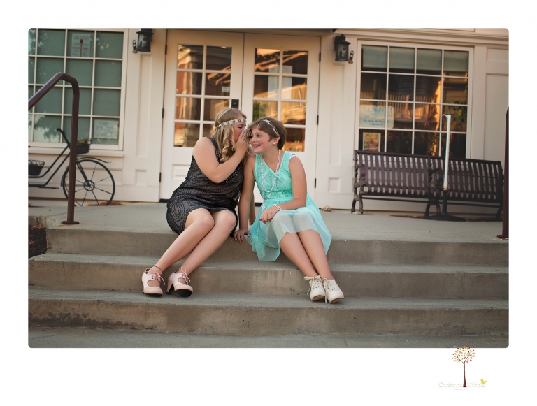 Sonora senior photographer Christine Dibble Photography takes portraits of two cousins dressed as flappers in Copperopolis Town Square before one leaves for college.