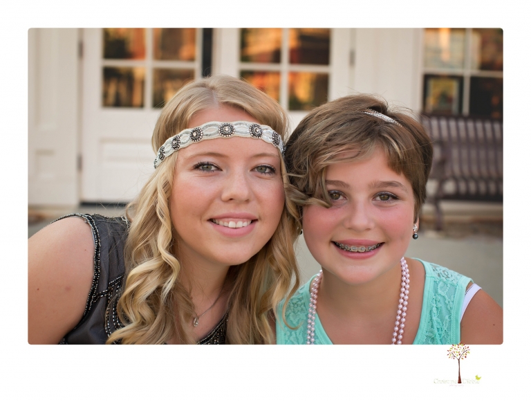 Sonora senior photographer Christine Dibble Photography takes portraits of two cousins dressed as flappers in Copperopolis Town Square before one leaves for college.