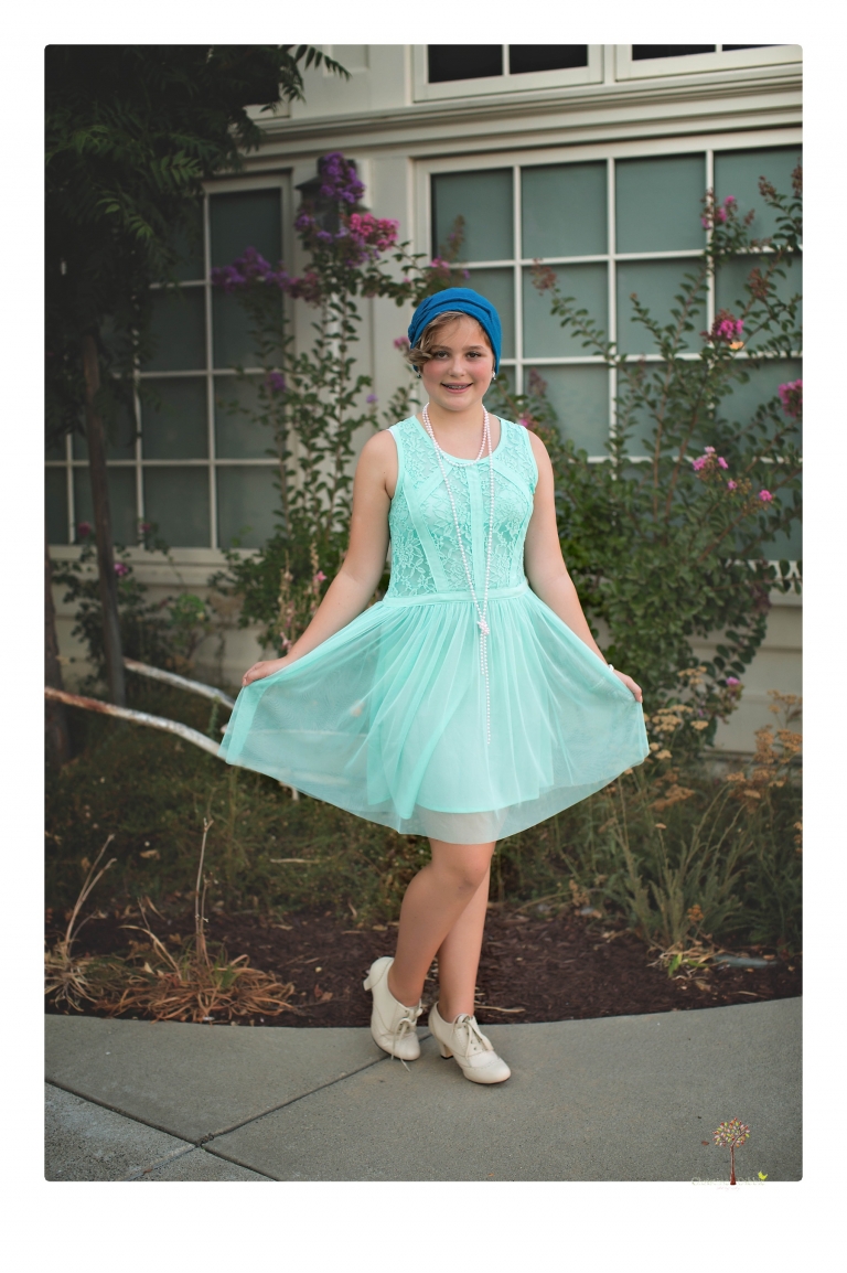 Sonora senior photographer Christine Dibble Photography takes portraits of two cousins dressed as flappers in Copperopolis Town Square before one leaves for college.