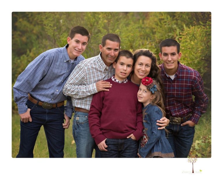 Sonora family photographer Christine Dibble Photography takes family portraits at Knights Ferry of a large family in perfectly coordinating outfits.