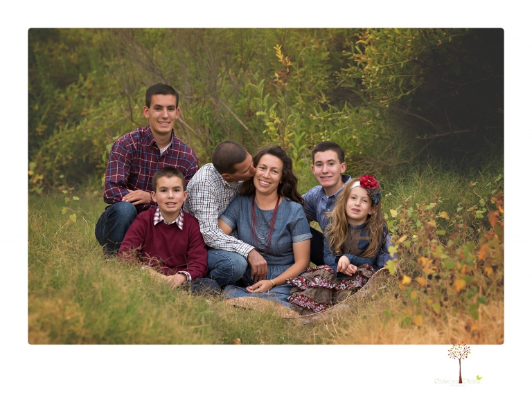 Sonora family photographer Christine Dibble Photography takes family portraits at Knights Ferry of a large family in perfectly coordinating outfits.