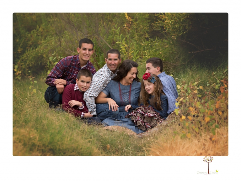 Sonora family photographer Christine Dibble Photography takes family portraits at Knights Ferry of a large family in perfectly coordinating outfits.