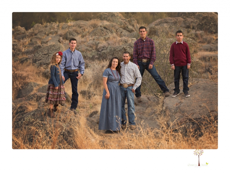 Sonora family photographer Christine Dibble Photography takes family portraits at Knights Ferry of a large family in perfectly coordinating outfits.