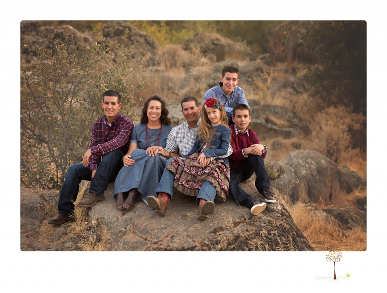 Sonora family photographer Christine Dibble Photography takes family portraits at Knights Ferry of a large family in perfectly coordinating outfits.