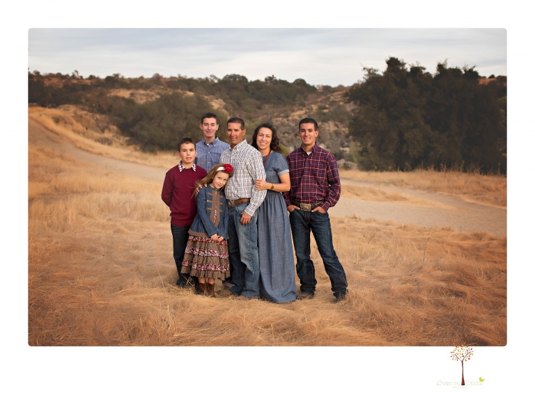 Sonora family photographer Christine Dibble Photography takes family portraits at Knights Ferry of a large family in perfectly coordinating outfits.
