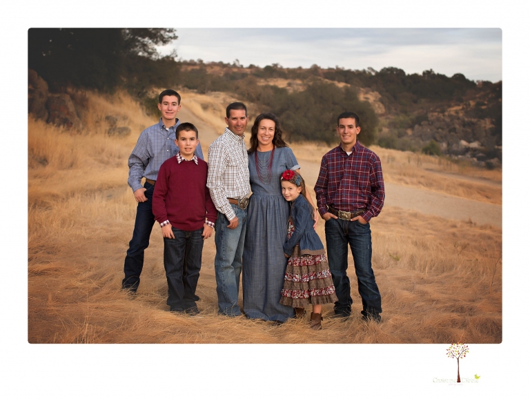 Sonora family photographer Christine Dibble Photography takes family portraits at Knights Ferry of a large family in perfectly coordinating outfits.