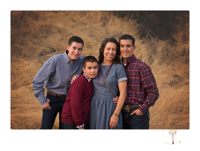 Sonora family photographer Christine Dibble Photography takes family portraits at Knights Ferry of a large family in perfectly coordinating outfits.