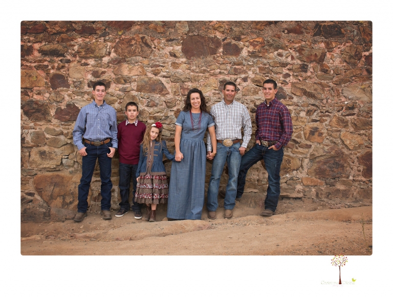 Sonora family photographer Christine Dibble Photography takes family portraits at Knights Ferry of a large family in perfectly coordinating outfits.