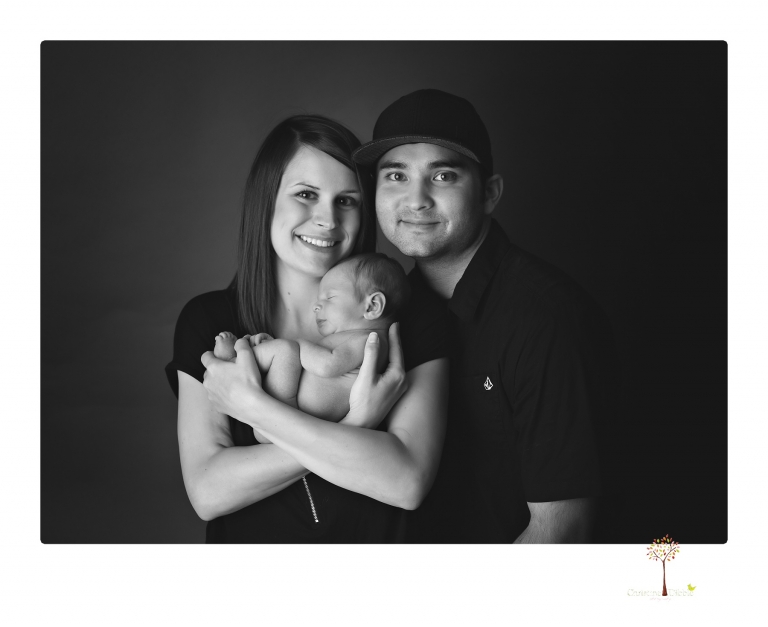 Best Sonora newborn photographer Christine Dibble Photography takes studio newborn portraits of a baby boy and his dog and the parents during a newborn portrait session.