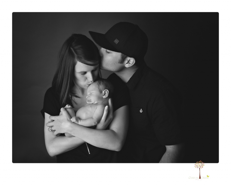 Best Sonora newborn photographer Christine Dibble Photography takes studio newborn portraits of a baby boy and his dog and the parents during a newborn portrait session.