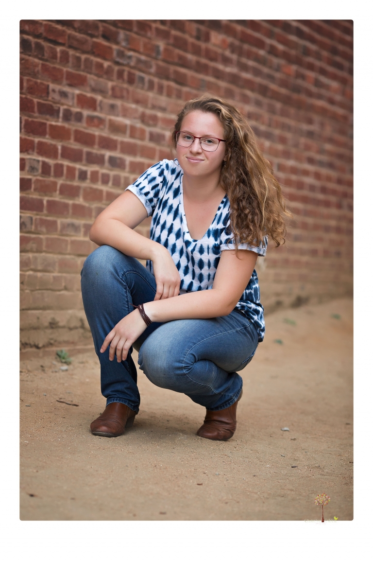 Sonora and Summerville High senior portrait photographer Christine Dibble Photography takes senior portraits of a Summerville High senior girl in Columbia State Historic Park with her moped and Edelweiss necklace.
