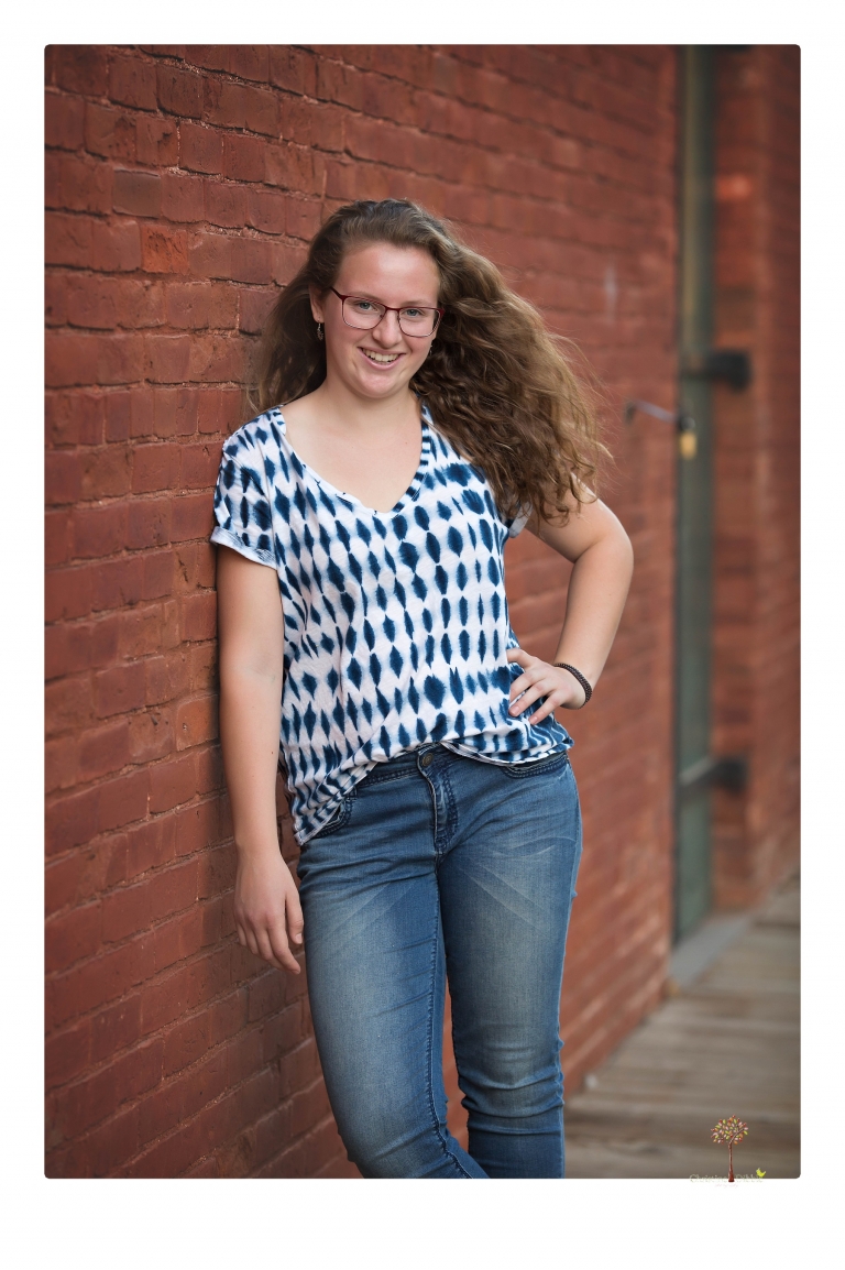 Sonora and Summerville High senior portrait photographer Christine Dibble Photography takes senior portraits of a Summerville High senior girl in Columbia State Historic Park with her moped and Edelweiss necklace.