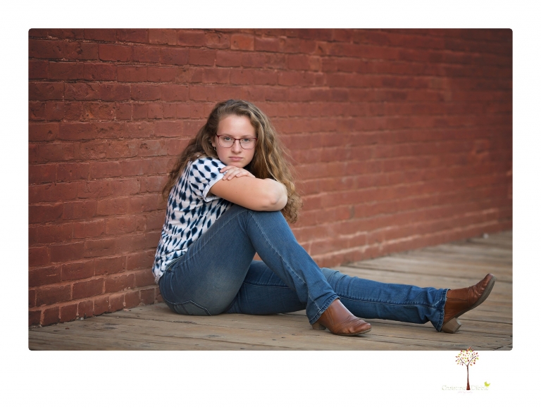Sonora and Summerville High senior portrait photographer Christine Dibble Photography takes senior portraits of a Summerville High senior girl in Columbia State Historic Park with her moped and Edelweiss necklace.