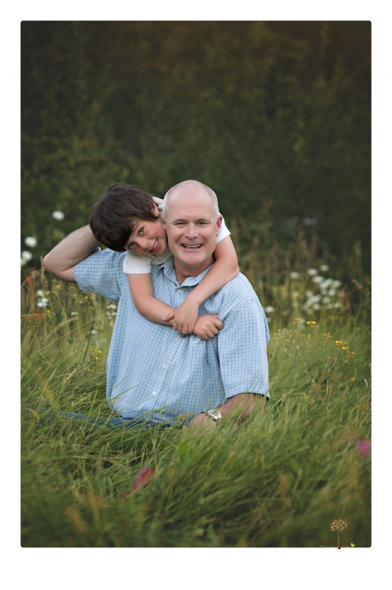 Sonora family photographer Christine Dibble Photography takes sunset family portraits in a field at Lake Tahoe in the summer.