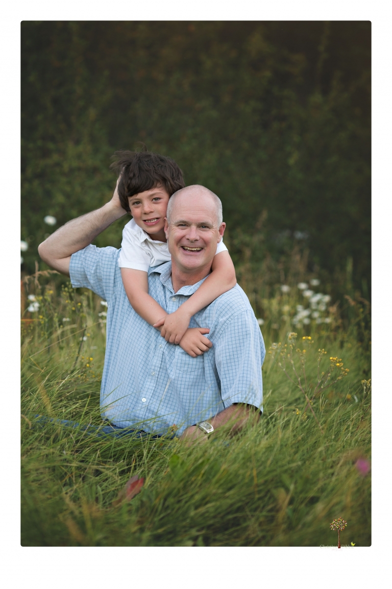 Sonora family photographer Christine Dibble Photography takes sunset family portraits in a field at Lake Tahoe in the summer.