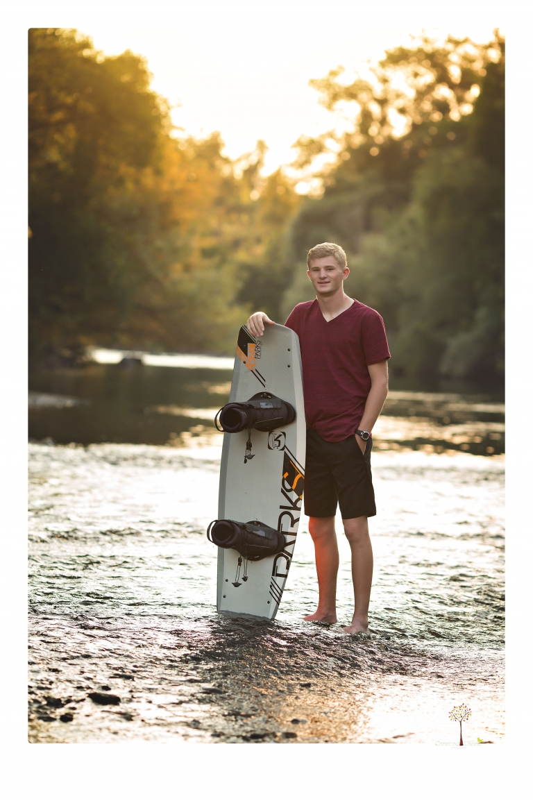 Summerville High senior portrait photographer Christine Dibble Photography of Sonora takes senior portraits of a wrestler at Knights Ferry with his wake board in the river, his jeep and letterman jacket.