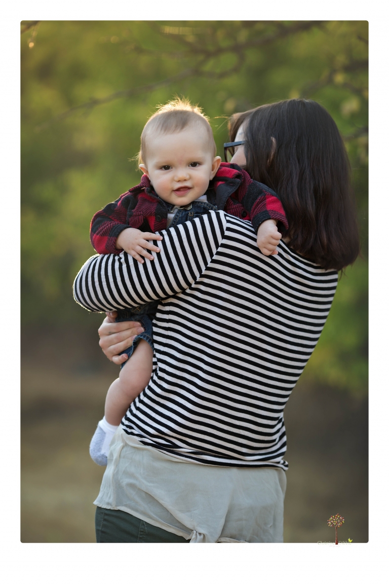Sonora baby photographer Christine Dibble Photography takes photos of an eight month old baby boy in a field in Columbia with a stuffed dog and pumpkins.