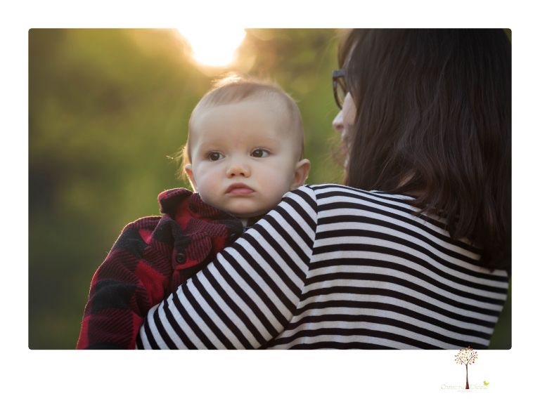 Sonora baby photographer Christine Dibble Photography takes photos of an eight month old baby boy in a field in Columbia with a stuffed dog and pumpkins.