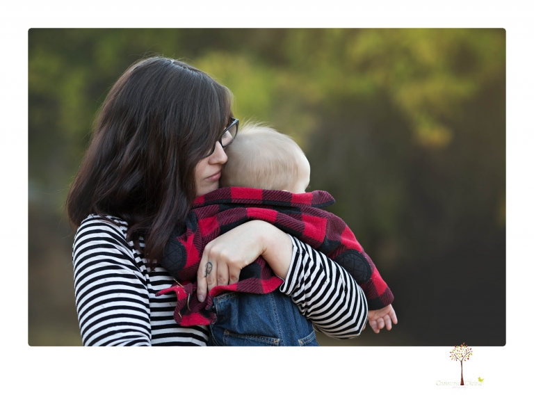 Sonora baby photographer Christine Dibble Photography takes photos of an eight month old baby boy in a field in Columbia with a stuffed dog and pumpkins.