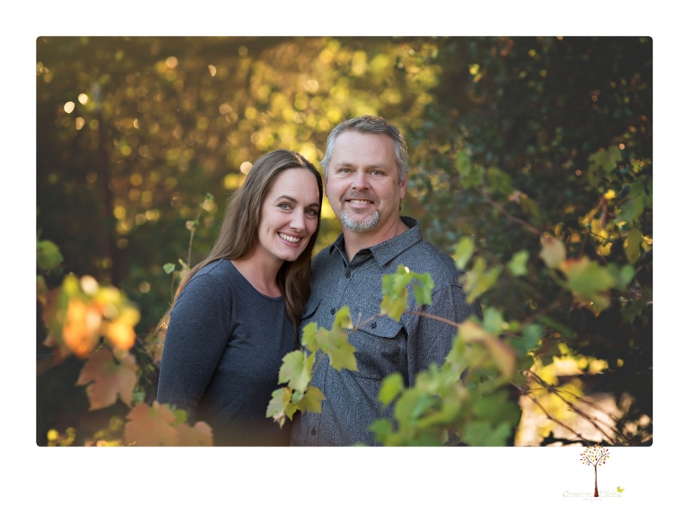 Sonora family photographer Christine Dibble Photography takes family portraits in a private vineyard as a family plays and climbs trees and rocks.