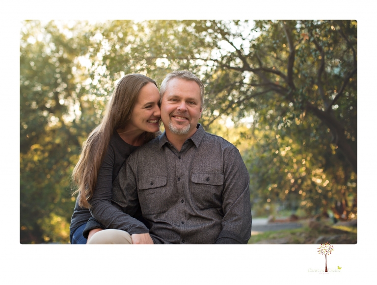 Sonora family photographer Christine Dibble Photography takes family portraits in a private vineyard as a family plays and climbs trees and rocks.