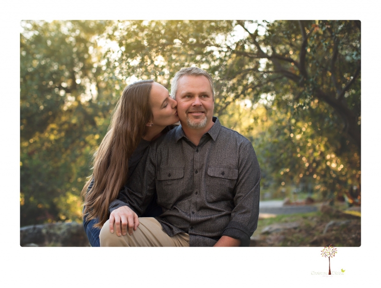 Sonora family photographer Christine Dibble Photography takes family portraits in a private vineyard as a family plays and climbs trees and rocks.