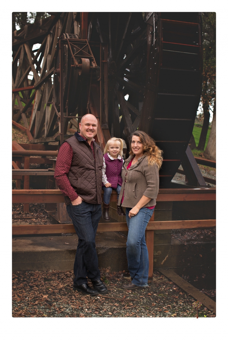 Murphys family photographer Christine Dibble Photography takes family portraits in the fall at Ironstone Vineyards of a family and grandparents as they play in colored leaves.