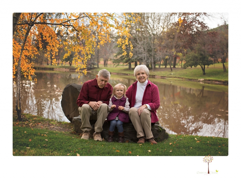 Murphys family photographer Christine Dibble Photography takes family portraits in the fall at Ironstone Vineyards of a family and grandparents as they play in colored leaves.