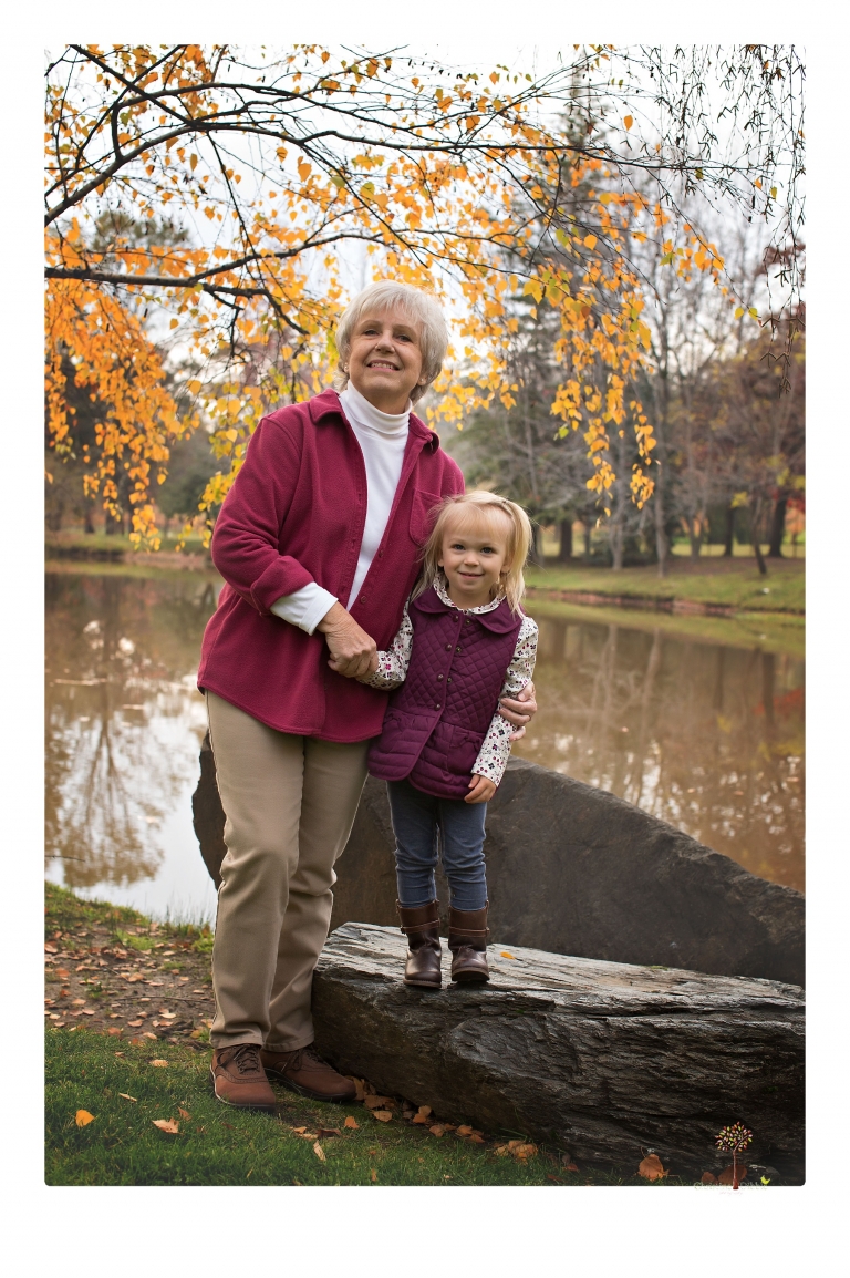 Murphys family photographer Christine Dibble Photography takes family portraits in the fall at Ironstone Vineyards of a family and grandparents as they play in colored leaves.