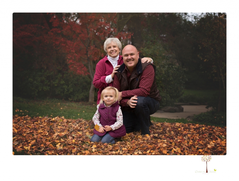 Murphys family photographer Christine Dibble Photography takes family portraits in the fall at Ironstone Vineyards of a family and grandparents as they play in colored leaves.