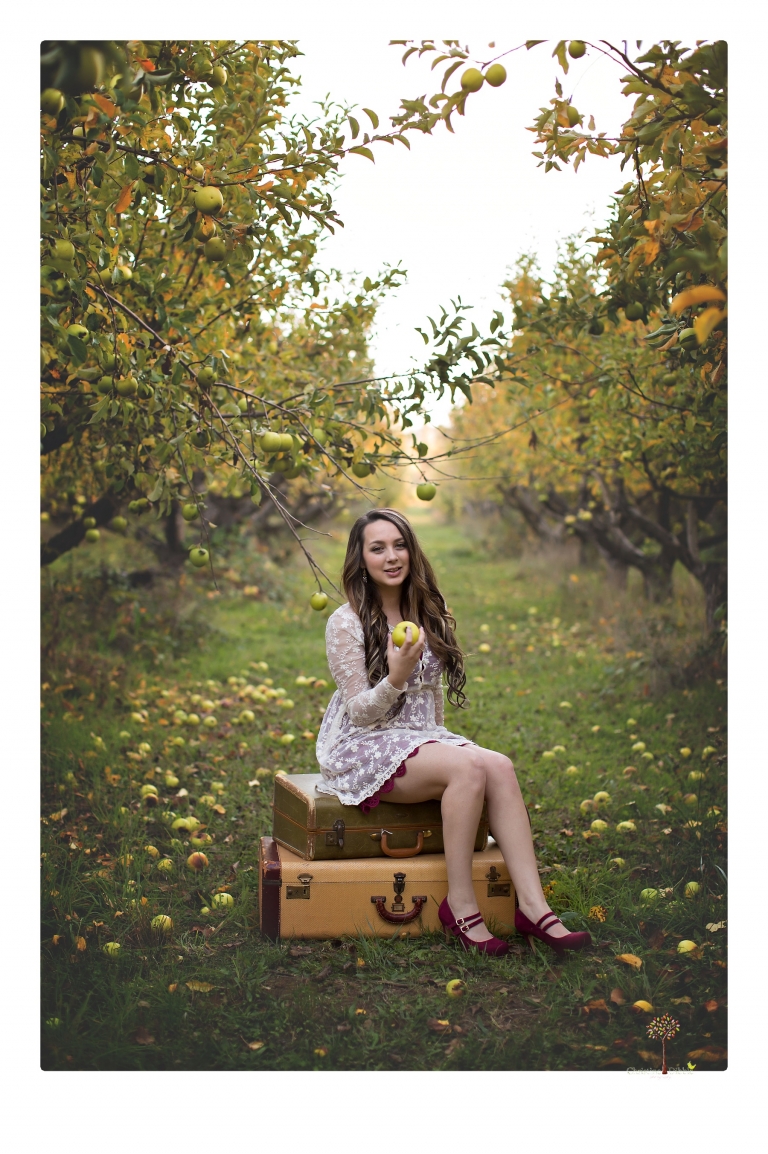 Sonora and Summerville Senior Portrait photographer Christine Dibble Photography takes senior portraits at Indigeny Reserve of a girl with vintage suitcases, a classic Ford Mustang, and her little dog, Pumpkin.