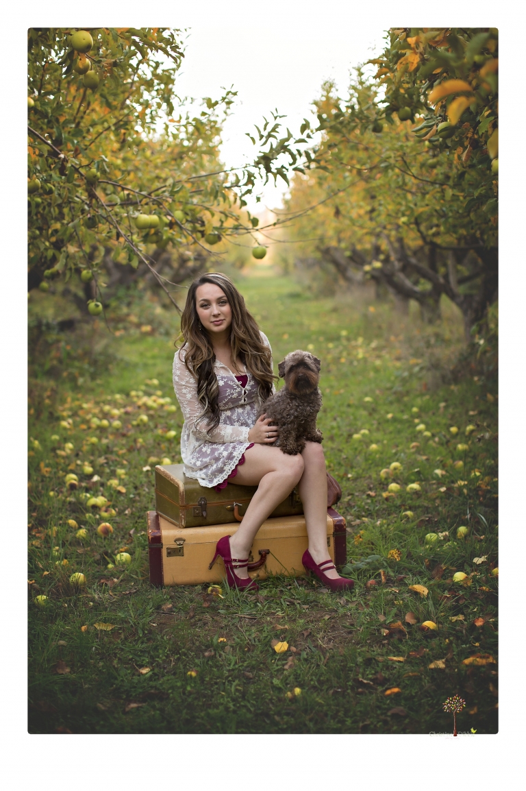 Sonora and Summerville Senior Portrait photographer Christine Dibble Photography takes senior portraits at Indigeny Reserve of a girl with vintage suitcases, a classic Ford Mustang, and her little dog, Pumpkin.