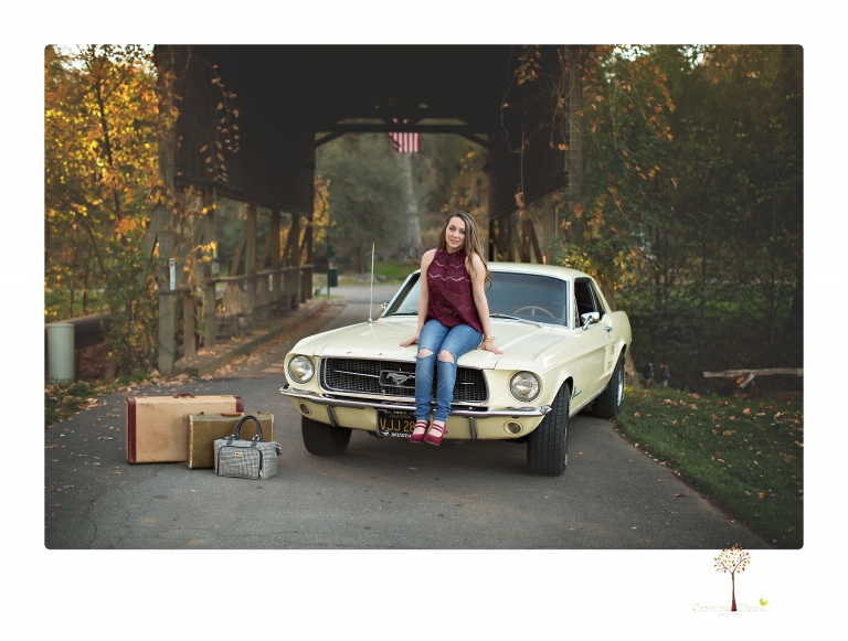 Sonora and Summerville Senior Portrait photographer Christine Dibble Photography takes senior portraits at Indigeny Reserve of a girl with vintage suitcases, a classic Ford Mustang, and her little dog, Pumpkin.