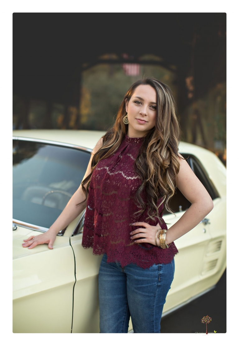 Sonora and Summerville Senior Portrait photographer Christine Dibble Photography takes senior portraits at Indigeny Reserve of a girl with vintage suitcases, a classic Ford Mustang, and her little dog, Pumpkin.