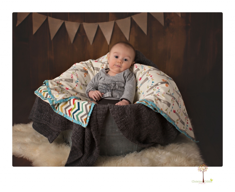 Sonora baby and child photographer Christine Dibble Photography takes three month portraits of a baby boy and his parents in the studio.