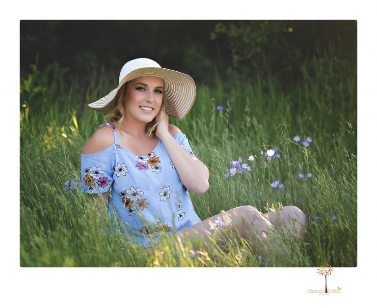 Sonora High senior portrait photographer Christine Dibble Photography takes senior portraits of a girl on her family's Chinese Camp ranch among wildflowers in a creek and with an American flag.