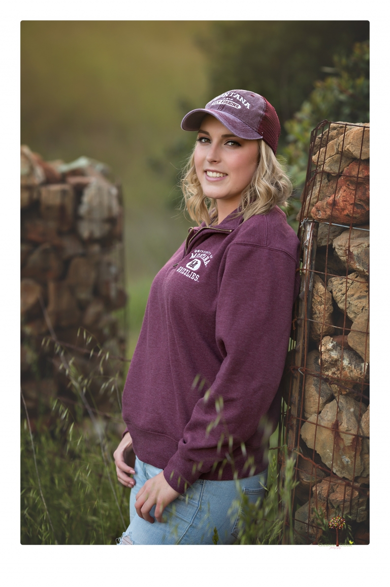 Sonora High senior portrait photographer Christine Dibble Photography takes senior portraits of a girl on her family's Chinese Camp ranch among wildflowers in a creek and with an American flag.