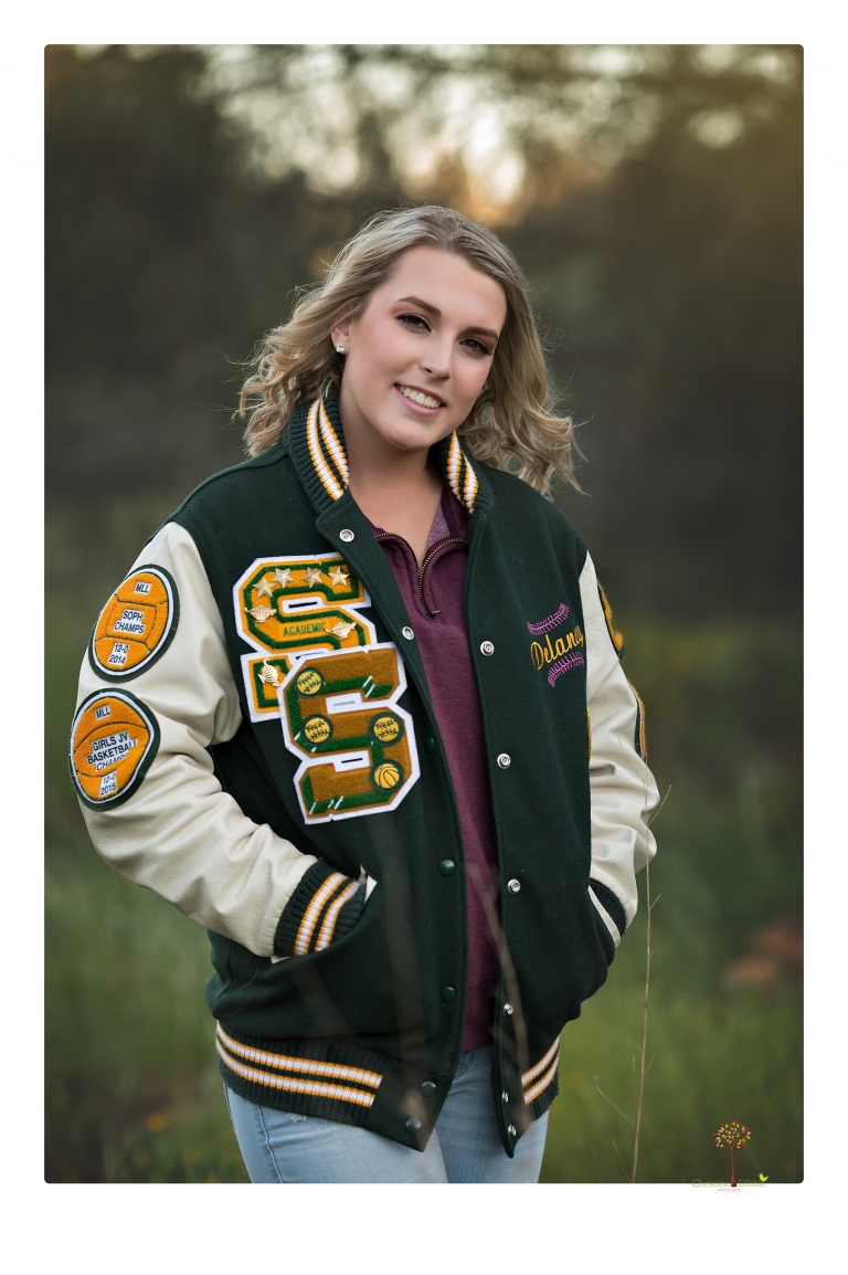 Sonora High senior portrait photographer Christine Dibble Photography takes senior portraits of a girl on her family's Chinese Camp ranch among wildflowers in a creek and with an American flag.