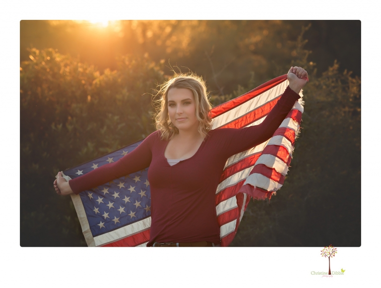Sonora High senior portrait photographer Christine Dibble Photography takes senior portraits of a girl on her family's Chinese Camp ranch among wildflowers in a creek and with an American flag.