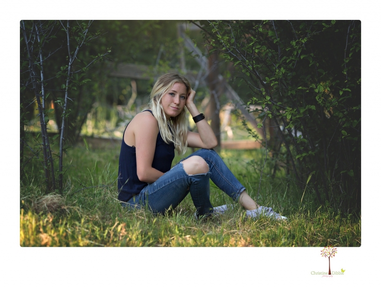 Sonora senior portrait photographer Christine Dibble Photography photographs a Sonora water polo graduate in her yard.